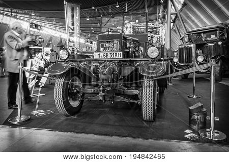 STUTTGART GERMANY - MARCH 18 2016: The tractor Lanz Bulldog D2531 (two-stroke hot bulb engine) manufactured by Heinrich Lanz AG in Mannheim 1939. Black and white. Europe's greatest classic car exhibition 