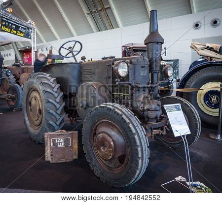 STUTTGART GERMANY - MARCH 18 2016: The tractor Lanz Bulldog D7511 (two-stroke hot bulb engine) manufactured by Heinrich Lanz AG in Mannheim 1935. Europe's greatest classic car exhibition "RETRO CLASSICS"