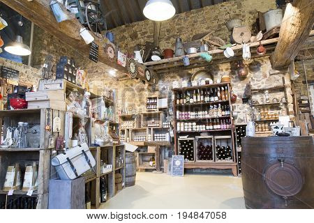 Valognes Normandy France - February 06 2014. Traditional typical delicatessen shop in Normandy. Shop of jams chutney alcohol biscuits pasta beer milk jam and retro products for decoration In wooden boxes