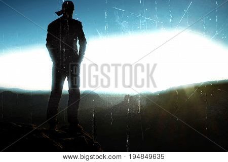 Film Grain. Hiker In Long Cap On Peak Of Rock In Rock Empires Park And Watching Over The Misty And F
