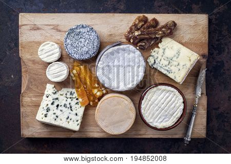 French Cheese Platter with Spanish Dulce de Membrillo as top view on a wooden board 