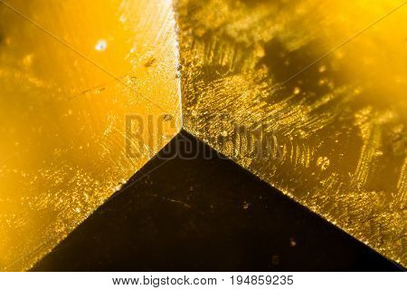 Yellow gem under the microscope. Closeup macro photography.