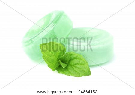 Candies for the throat with sprig of mint isolated on a white background.