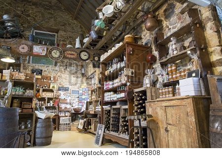 Valognes Normandy France - February 06 2014. Traditional typical delicatessen shop in Normandy. Shop of jams chutney alcohol biscuits pasta beer milk jam and retro products for decoration In wooden boxes