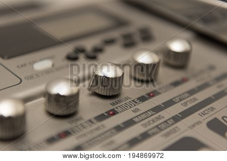 Details of Guitar Music Recording Equipment with Chrome Knobs.