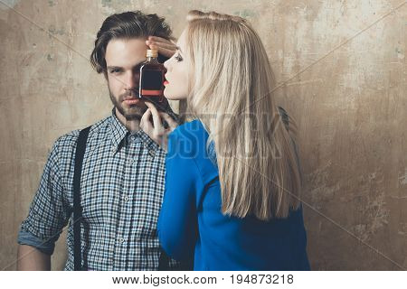 Girl And Man Posing With Liqueur Bottle