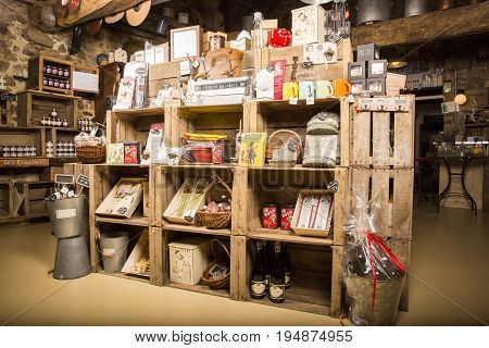 Valognes Normandy France - February 06 2014. Traditional typical delicatessen shop in Normandy. Shop of jams chutney alcohol biscuits pasta beer milk jam and retro products for decoration In wooden boxes