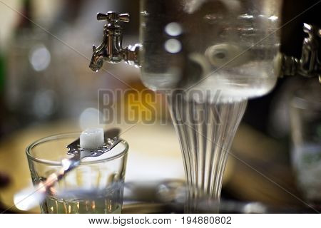Classic ritual of glass of absinth and dripping fountain.