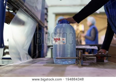 ST. PETERSBURG, RUSSIA - JUNE 29, 2017: Worker prepares can for packaging in the drinking water factory of Lider-Aqua  LTD. The factory is certified by regional quality certification program