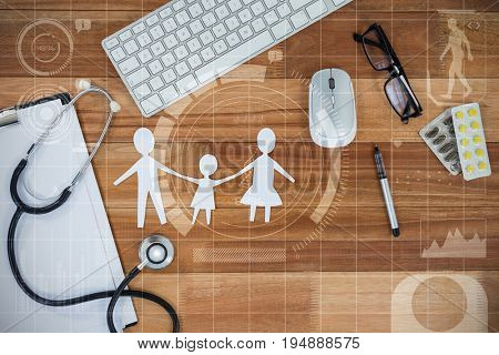 Human development illustration over black background against paper cut out family chain with various medical equipment and keyboard