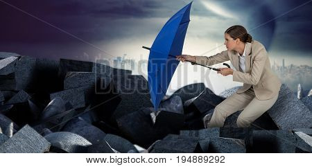 Full length of businesswoman defending with blue umbrella  against full frame shot of sky