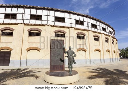 Lorca Spain - May 29 2017: Historic bullfight arena in Lorca with monument to the famous torero Pepin Jimenez. Province of Murcia Spain