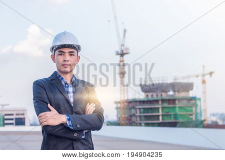 Portrait of architect wear white helmet safty on construction site with crane background
