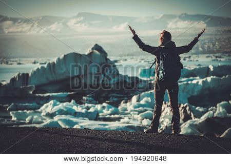 Woman explorer lookig at Jokulsarlon lagoon, Iceland.
