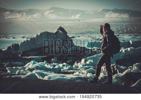 Woman explorer lookig at Jokulsarlon lagoon, Iceland.