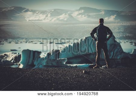 Man explorer lookig at Jokulsarlon lagoon, Iceland.