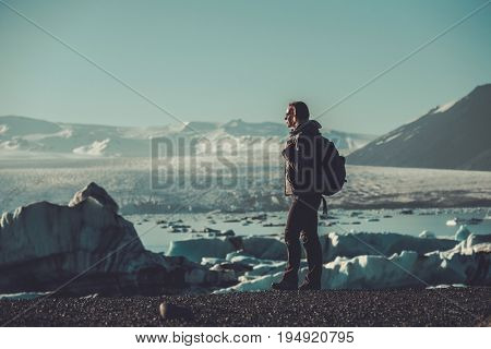 Woman explorer lookig at Jokulsarlon lagoon, Iceland.