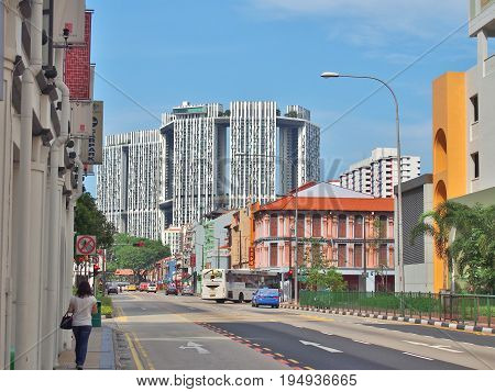 SINGAPORE - MAY 9, 2015: The junction of South Bridge Road with Upper Cross Street in Singapore's Chinatown. The big white buildings are actually public housing buildings called The Pinnacle@Duxton.