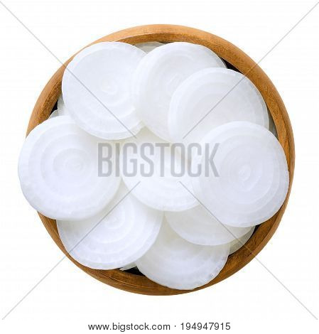 White onion slices in wooden bowl. Fresh, raw Allium cepa, also known as bulb or common onion. Vegetable, ingredient and staple food. Isolated macro food photo close up from above on white background.