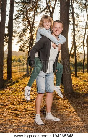 young loving couple in a park at sunset