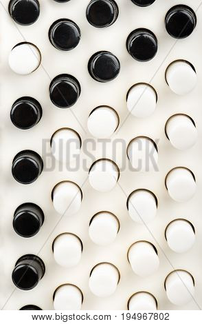 Black and white keys of an old accordion closeup