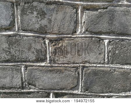 Texture of old blocks on cement wall in vintage style; untidy masonry; use uneven sizes of grey concrete bricks
