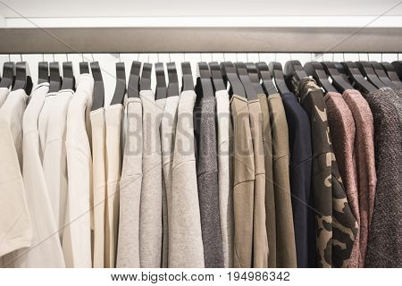 Men's sweaters on hangers in the store