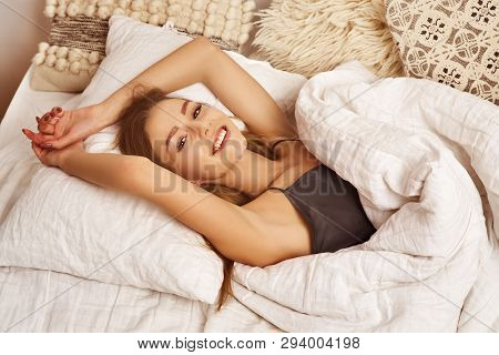 Pleased Female Smiles Happily, Sleeps Well In Cozy Bed, Enjoys Healthy Good Sleep Or Nap, Expresses 