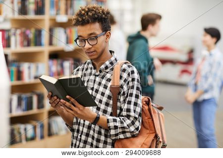 Serious Pensive Intelligent African-american Guy In Glasses Wearing Casual Satchel Standing In Libra