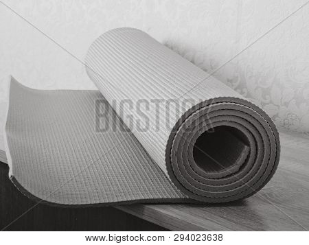 Woman Rolling Her Yoga Mat After A Workout - Top View.equipment For Yoga. Rolled Up Yoga Mat Isolate