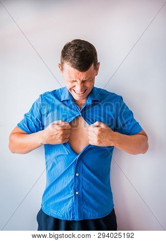 Businessman Tearing Off His Shirt And Showing Mucular Body Concept On Background
