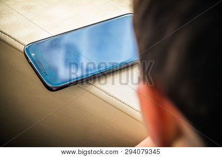 Little Boy Using A Mobile Phone At Home