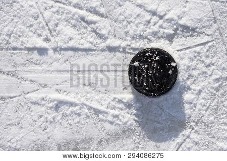 Hockey Puck Lies On The Ice In The Stadium