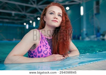 Beautiful Young Woman In The Indoor Swimming Pool. Athletic Sexy Girl. Healthy Lifestyle. Wellnes We