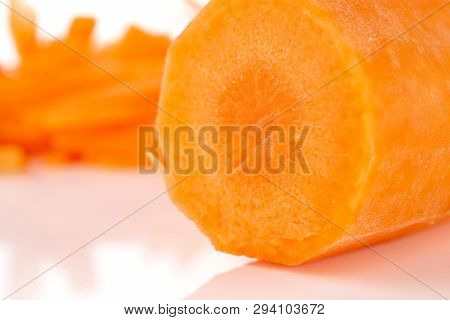 Macro Closeup Of One Half Lot Of Pieces Of Fresh Orange Carrot Isolated On White Background