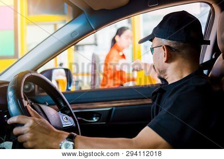 Selective Focus To The Man Driving The Car Is Paying The Expressway