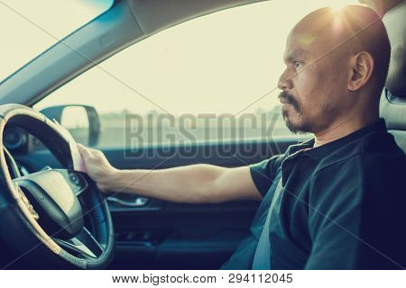 Selective Focus To The Man Driving The Car Is Paying The Expressway