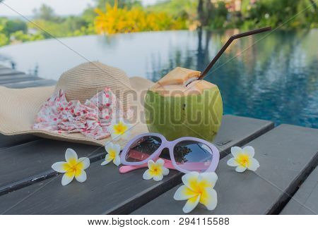 Coconut, Glasses And Hat At The Swimming Pool.summer Concept