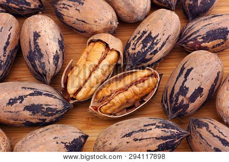 Pecan Nuts On A Wooden Table. Cllose Up.