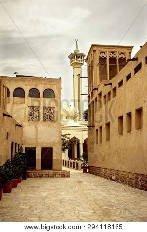 View On A Mosque In Old Dubai And A Traditional Wind Tower In Old Dubai.