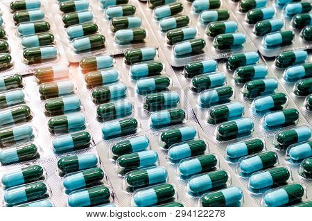 Closeup Green-blue Antibiotic Capsule Pills In Blister Pack. Antimicrobial Drug Resistance. Pharmace