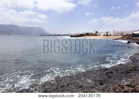 Rocks And White Houses At The Coast Of Caleta De Sebo On The Island La Graciosa Of Lanzarote
