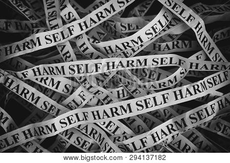 Crumpled Paper Pieces With Words Self Harm. Close Up.