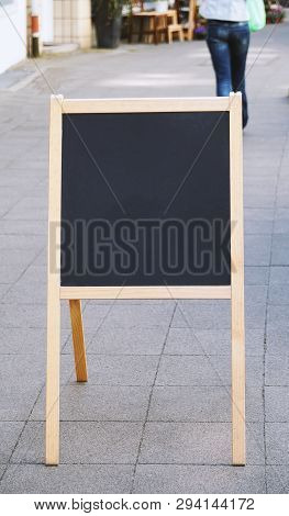 Empty Blank Customer Stopper Blackboard Advertising Sign Or Menu Board Standing On Sidewalk In City