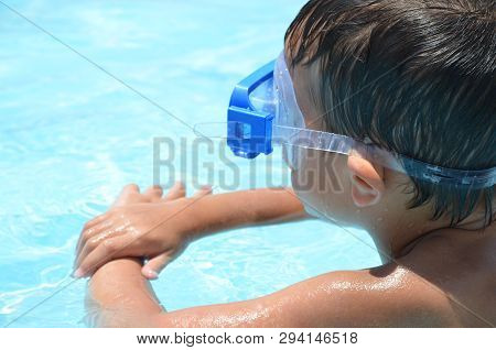 Teenager Boy Wearing Mask Swimming In The Pool. Happy Holiday Concept. Cute Happy Little Boy Swimmin
