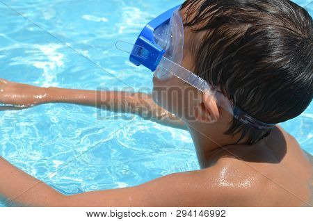 Teenager Boy Wearing Mask Swimming In The Pool. Happy Holiday Concept. Cute Happy Little Boy Swimmin