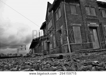 Abandoned Brick Train Depot With Tracks And Graffiti