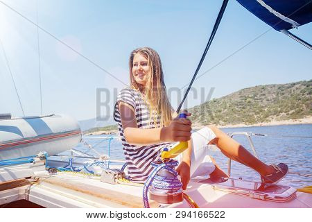 Girl On Board Of Sailing Yacht On Summer Cruise. Travel Adventure, Yachting With Child On Family Vac
