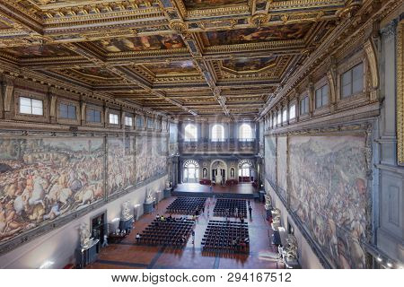FLORENCE, ITALY - AUGUST 10, 2018: People in the Hall of the Five Hundred, Salone dei Cinquecento in Palazzo Vecchio. It is the largest room in Italy made for a civil power palace