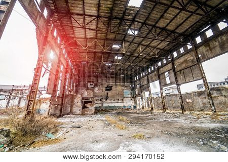 Abandoned Ruined Industrial Warehouse Or Factory Building Inside, Corridor View With Ruins And Pitte